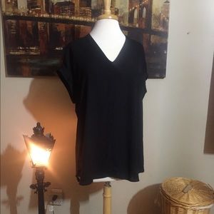 Solid black mixed material top. Cuffed sleeves